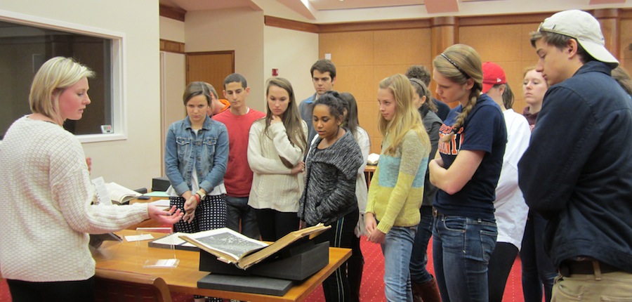 Ally Clement gives her classmates a "tour" of her mini-exhibition in preparation for Tales from Under Grounds. 