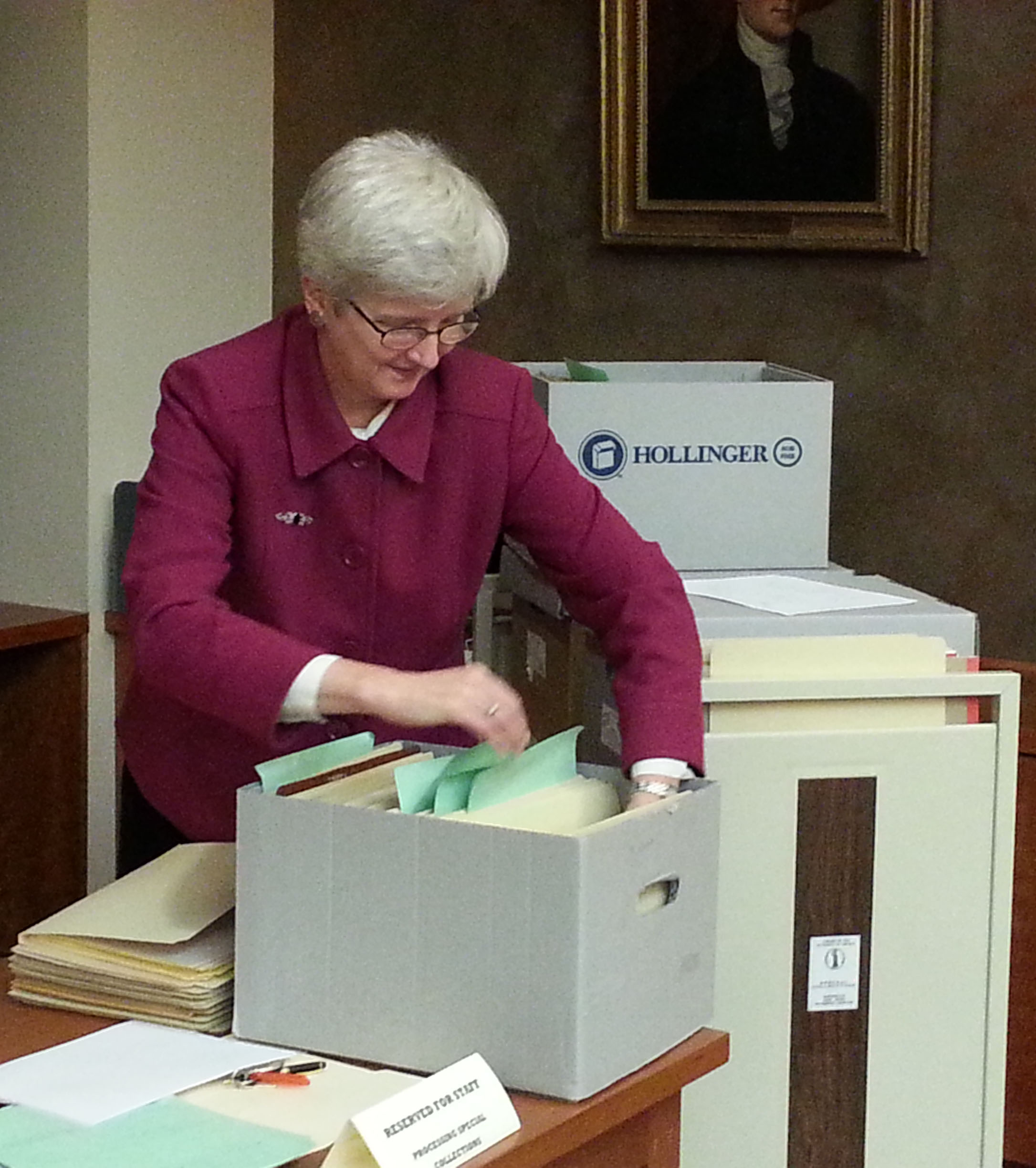 Professor Parshall hard at work. Not only did she organize all the materials, she rehoused the entire collection, replacing dusty old file folders and boxes with fresh archival ones.