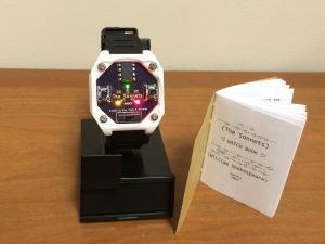 Pictured here is the watch with the instructional booklet open to the title page. 