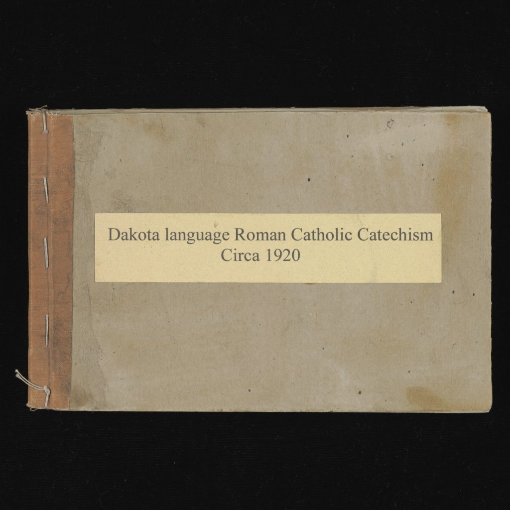 Simple side-sewn binding with title, "Dakota language Roman Catholic Catechism / Circa 1920"