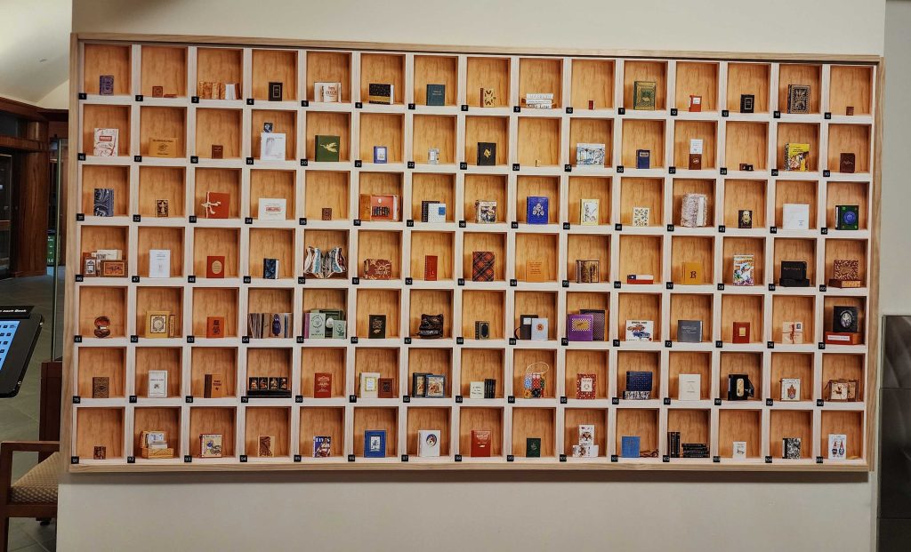 Miniature Book wall display featuring 100 different miniature books.